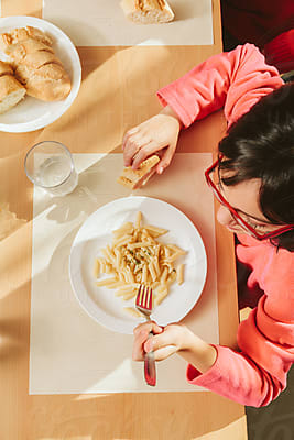 Kindergarten Kids Eating At School Canteen by Stocksy Contributor VICTOR  TORRES - Stocksy