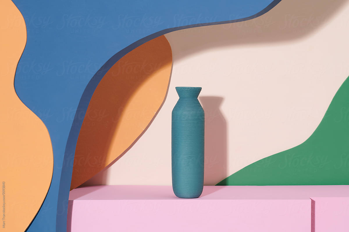 Beautiful ceramic vases on table against colorful wall with space
