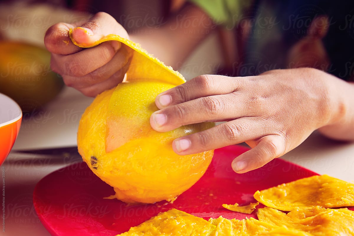 Close up of mango being peeled