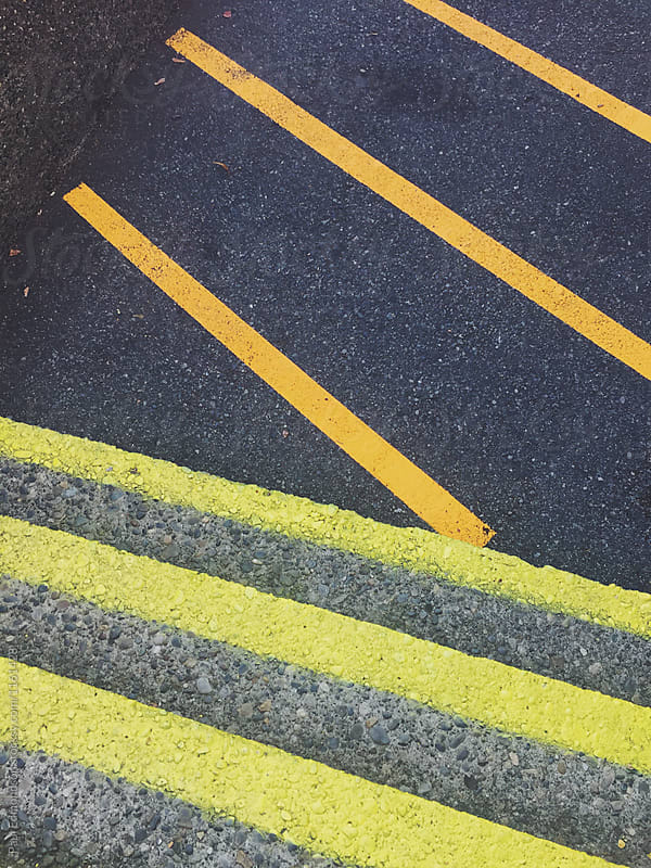 Freshly painted orange and yellow caution lines on steps and street