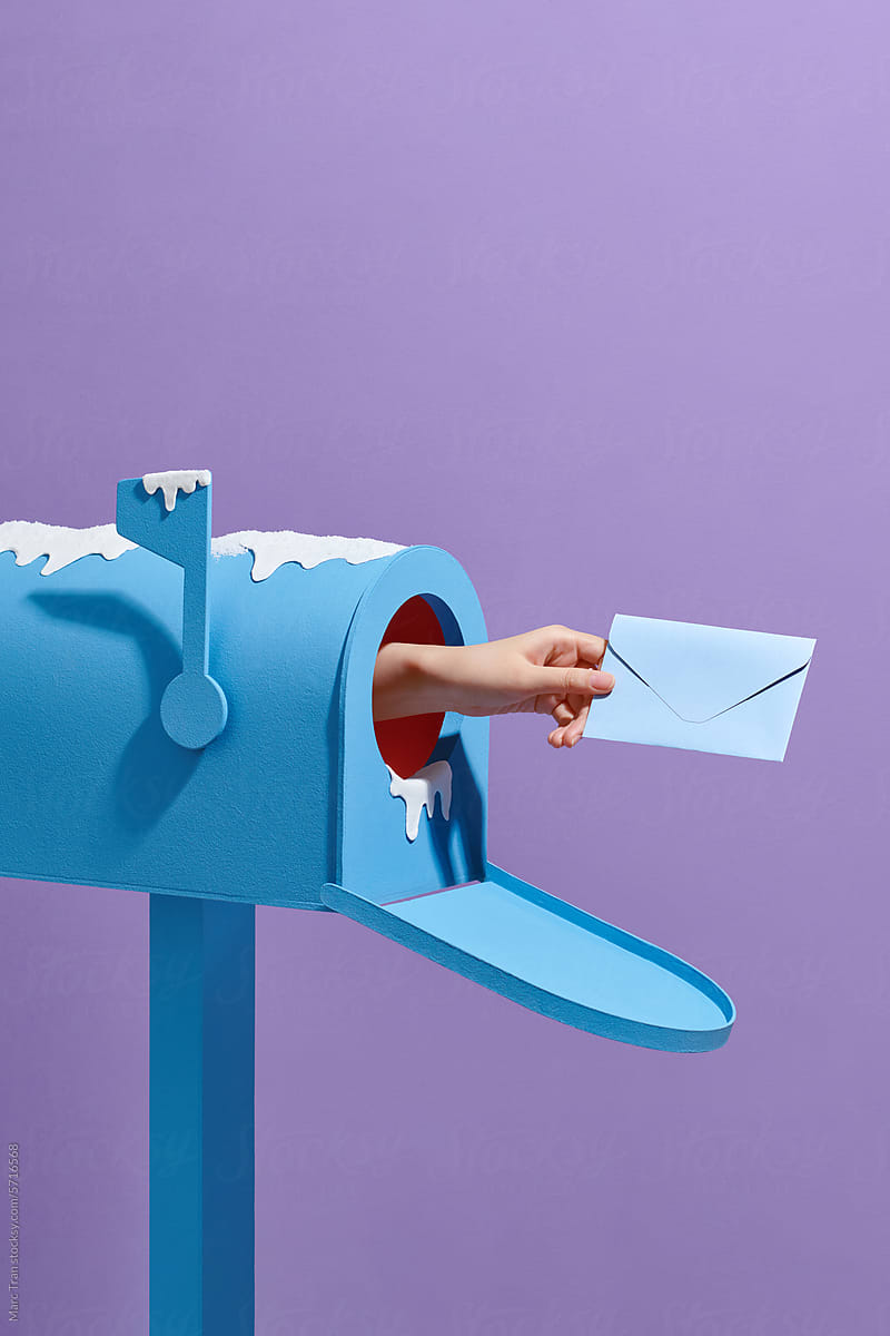 Hand sending letters out of a mailbox isolated on color background