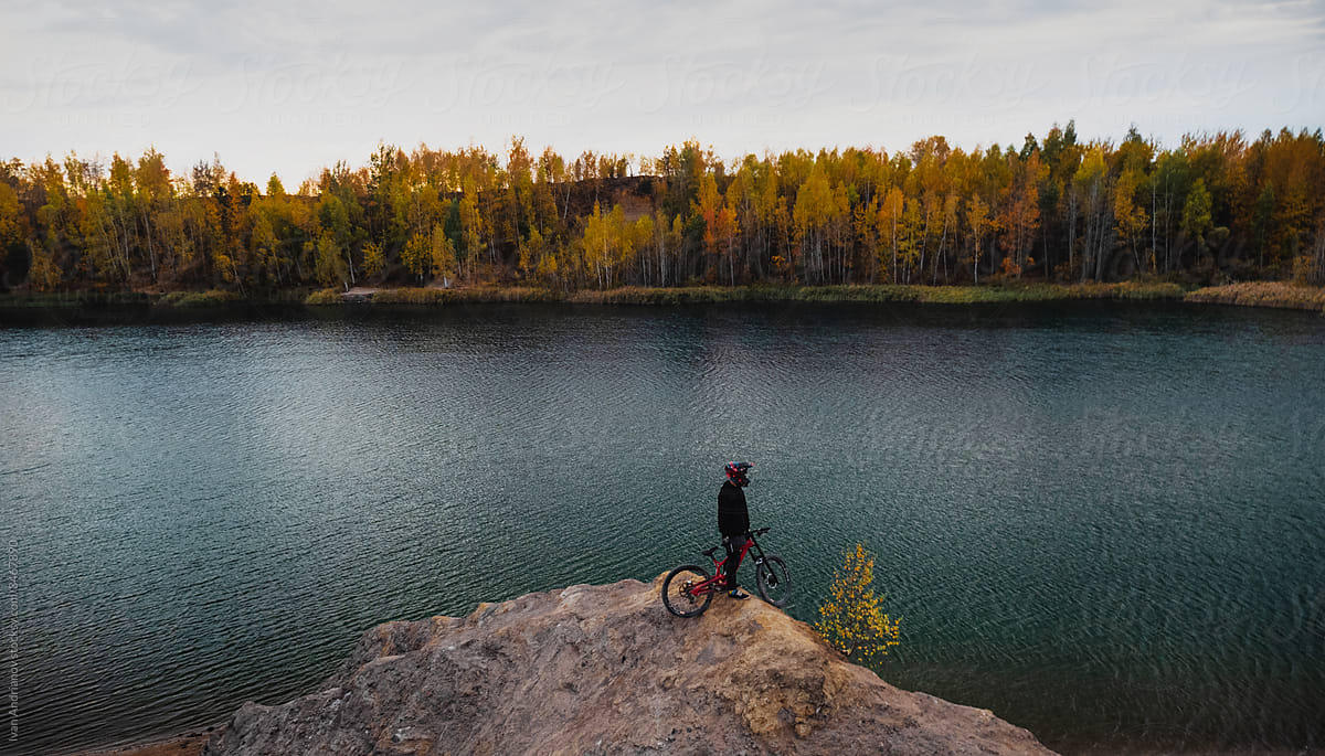 Person WIth Bike Near Lake Autumn Landscape