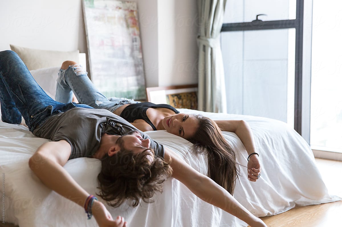 Couple Relaxing On Bed Together In Bright Bedroom By Stocksy Contributor Jovo Jovanovic 6499