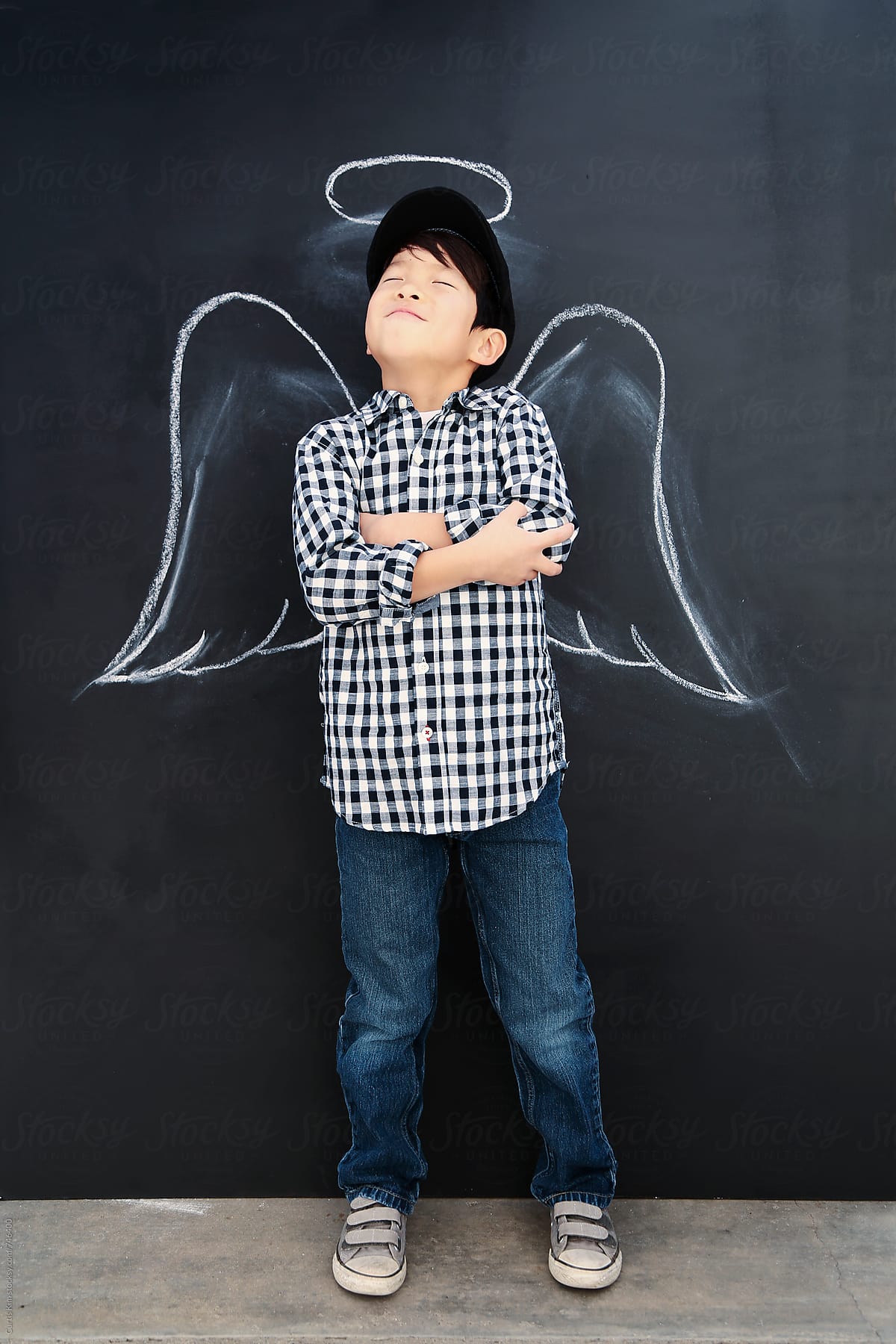 Handsome kid with angel wings and halo around his head