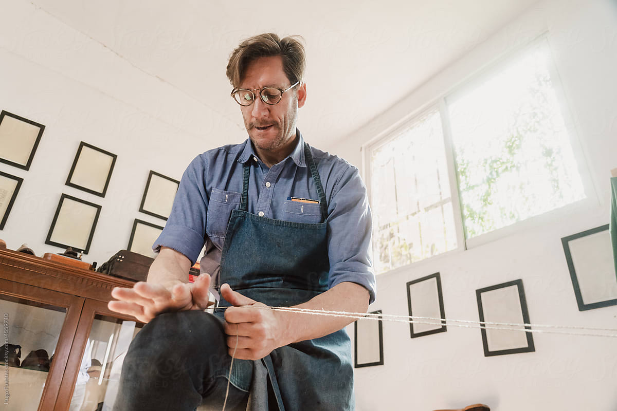 Male Artisan Shoemaker in handcraft workshop