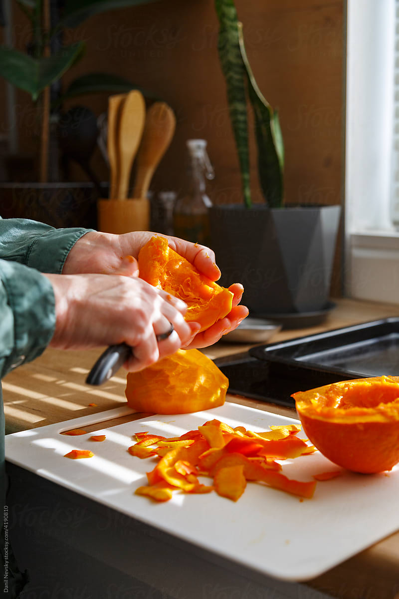 Woman preparing pumpkin for meal