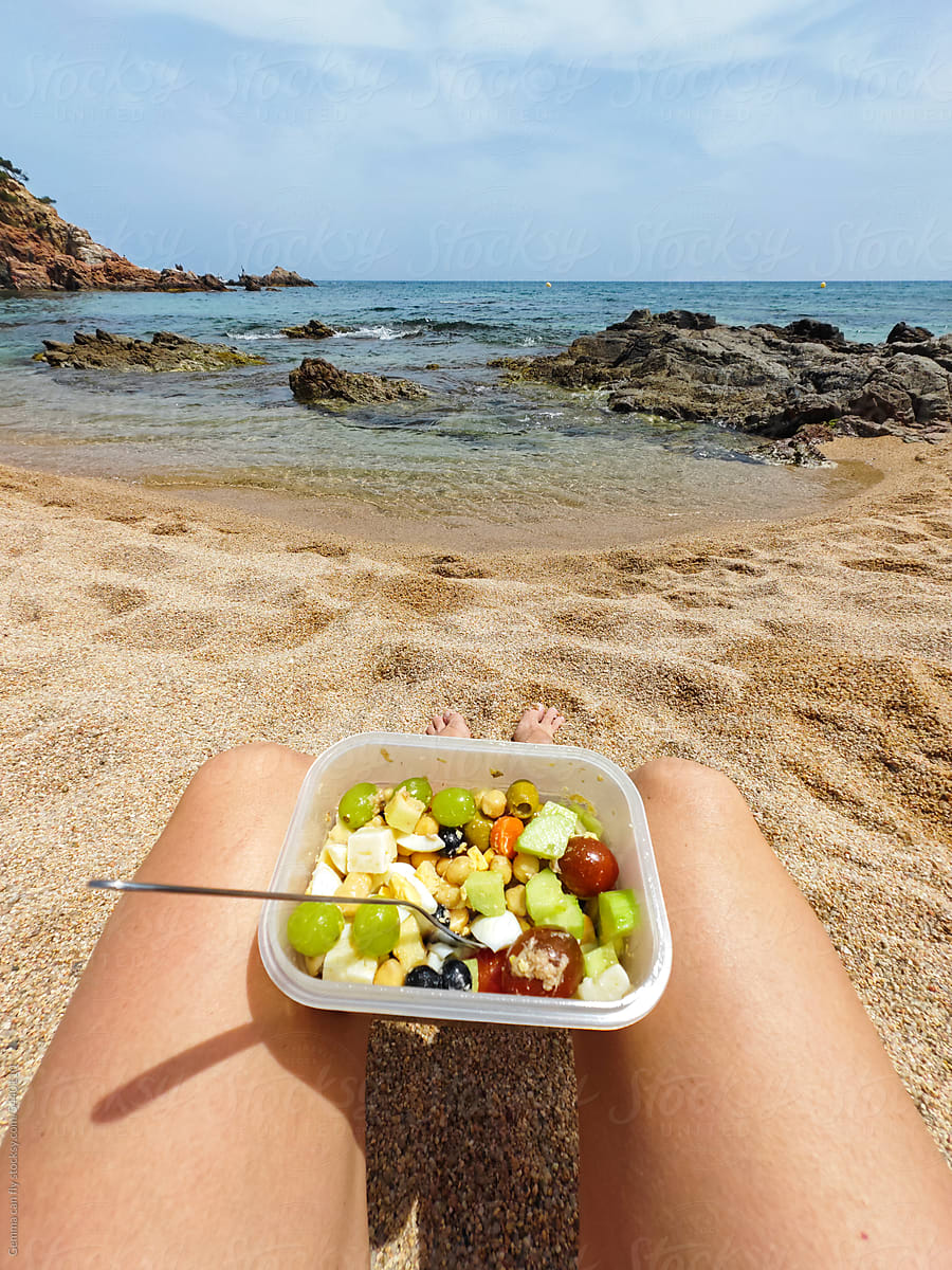 Healthy lunch box on the beach. Summer POV
