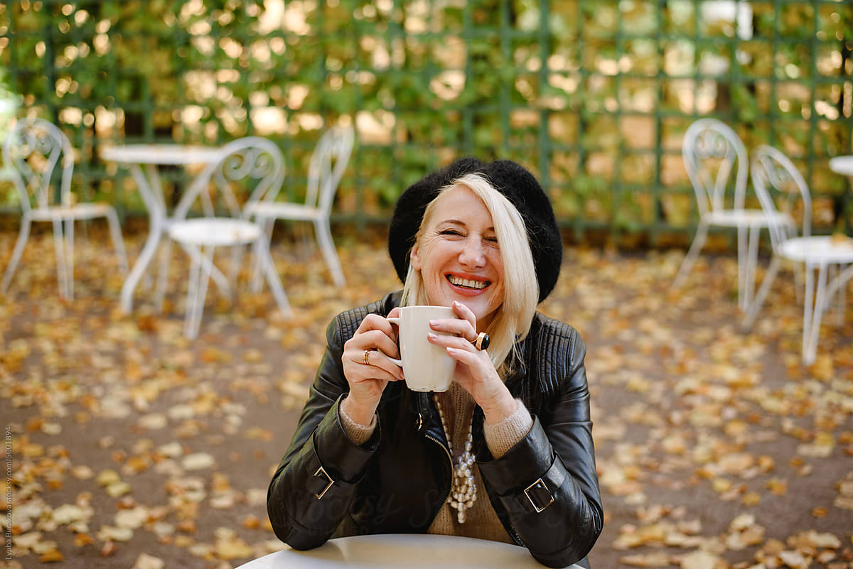 Cheerful woman having coffee