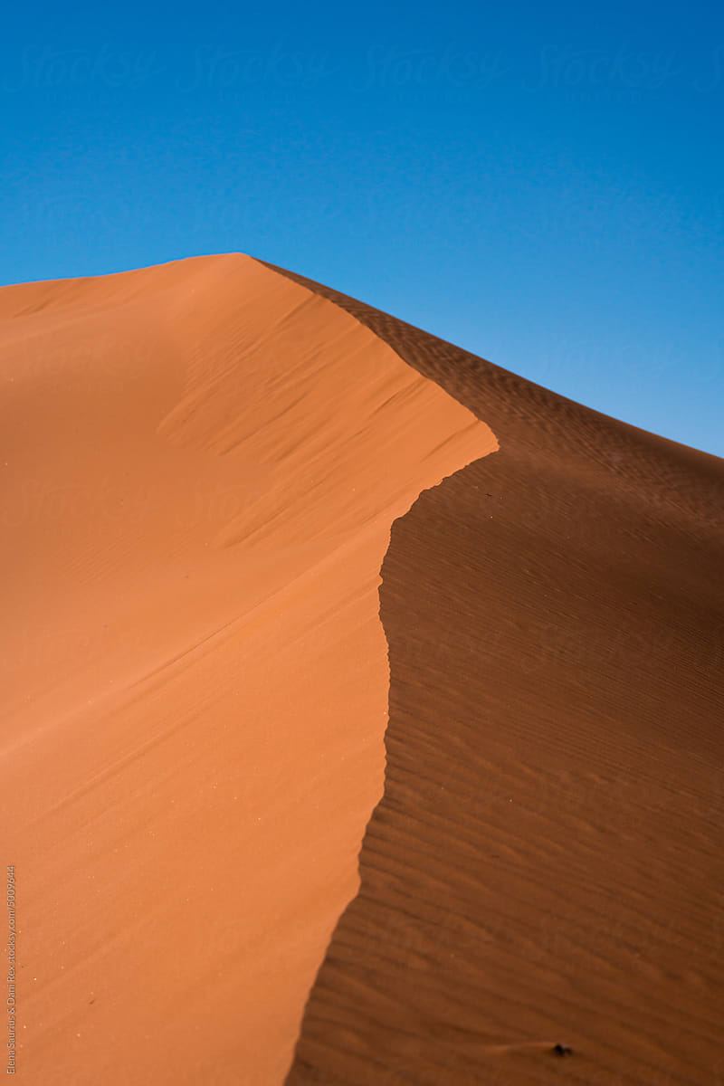 Detail of a sand dune in Namib desert, with blue and clean sky, Africa