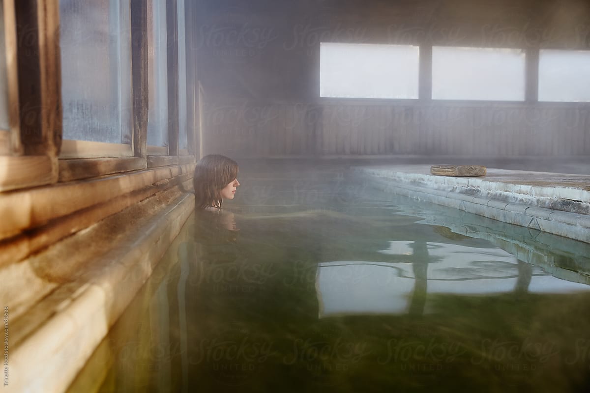 Woman relaxing in water at Japanese spa and hot springs