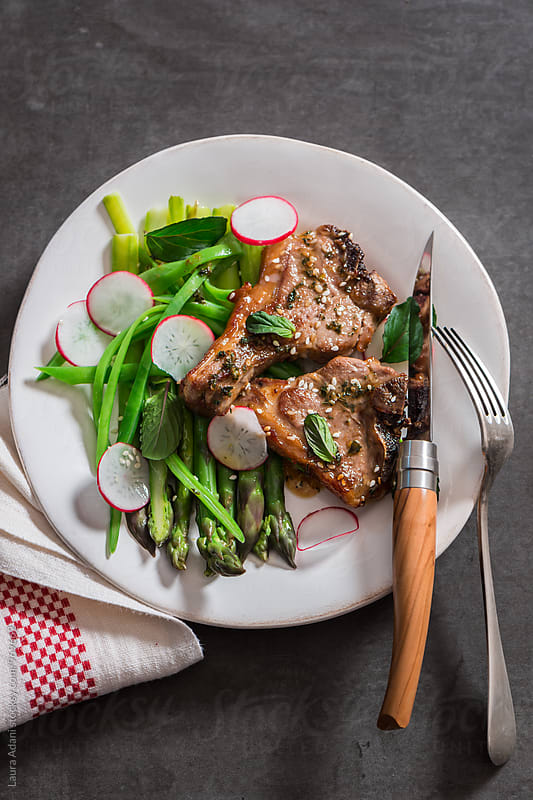 Sauteed lamb chops with asparagus and radishes salad