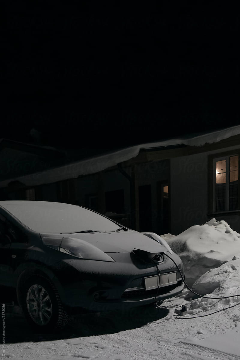 Electric car charging in winter night