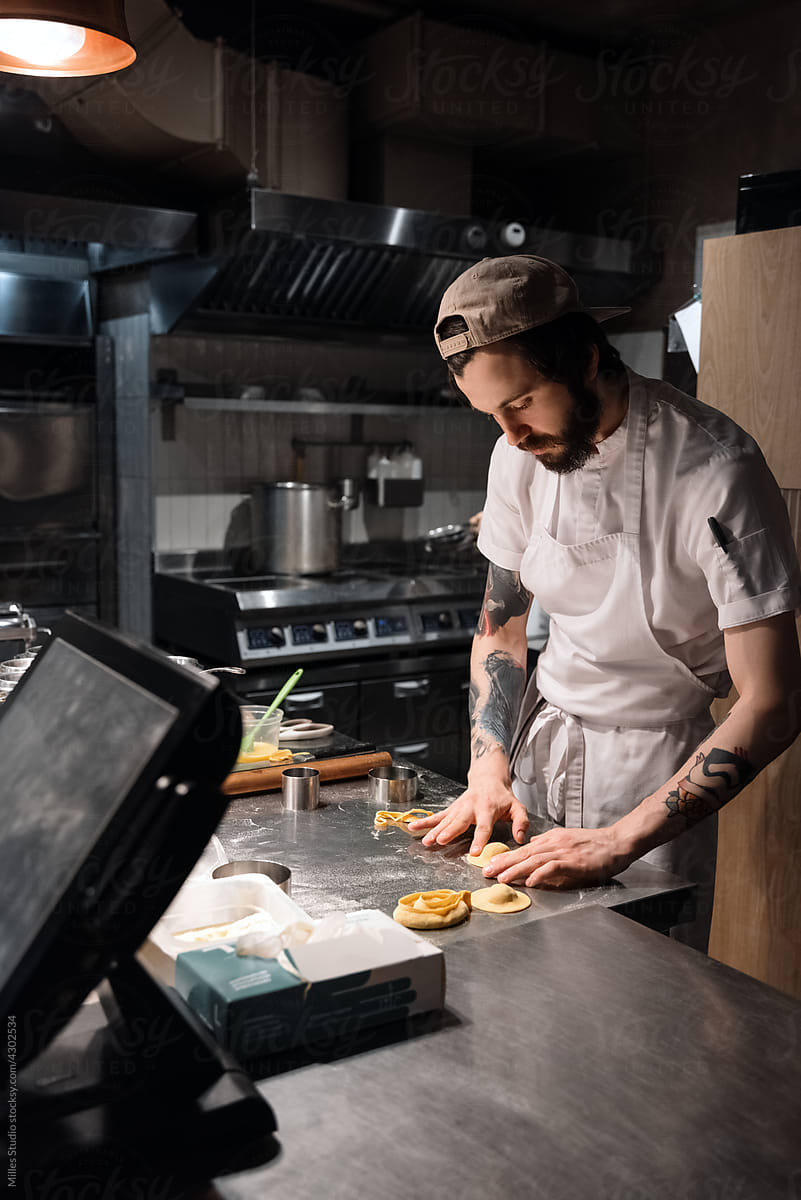 Bearded chef making ravioli during work