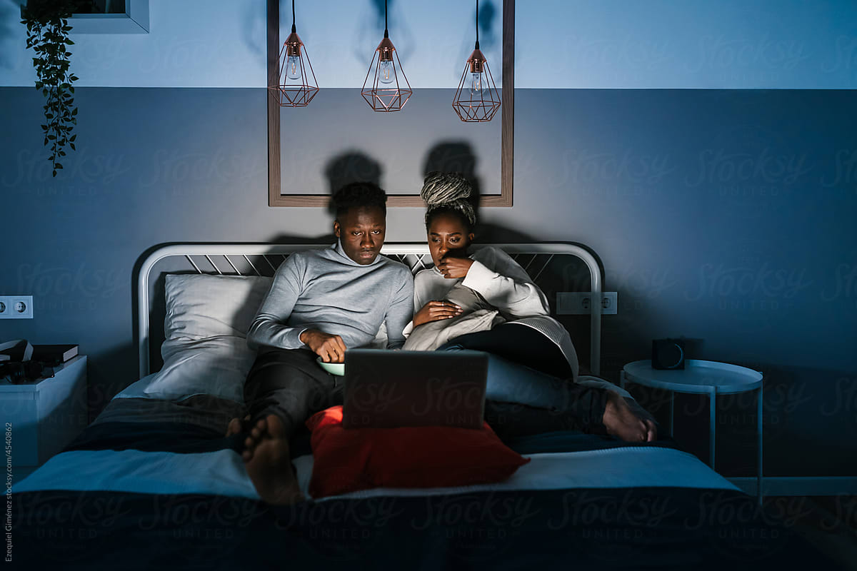 Couple watching movie at night