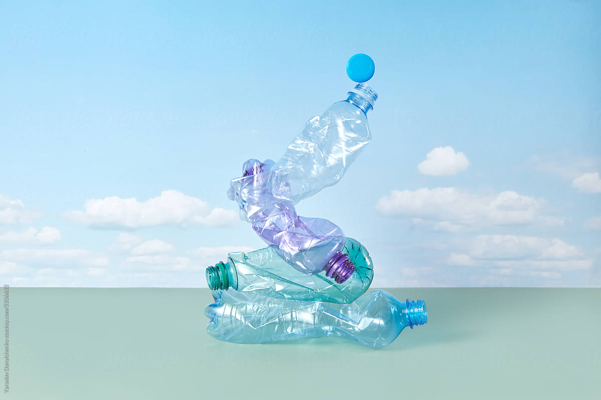 Crumpled plastic bottles on blue sky background.