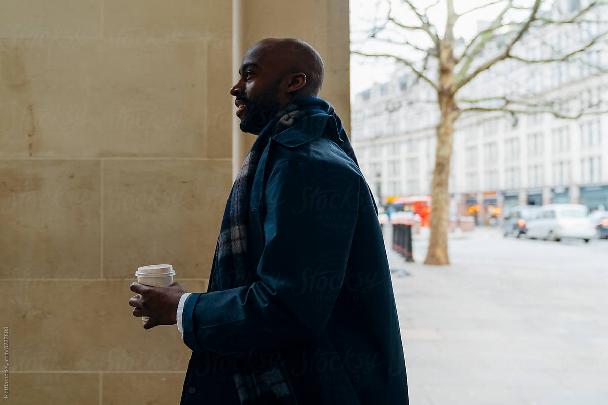 Black Businessman Walking with a Coffee