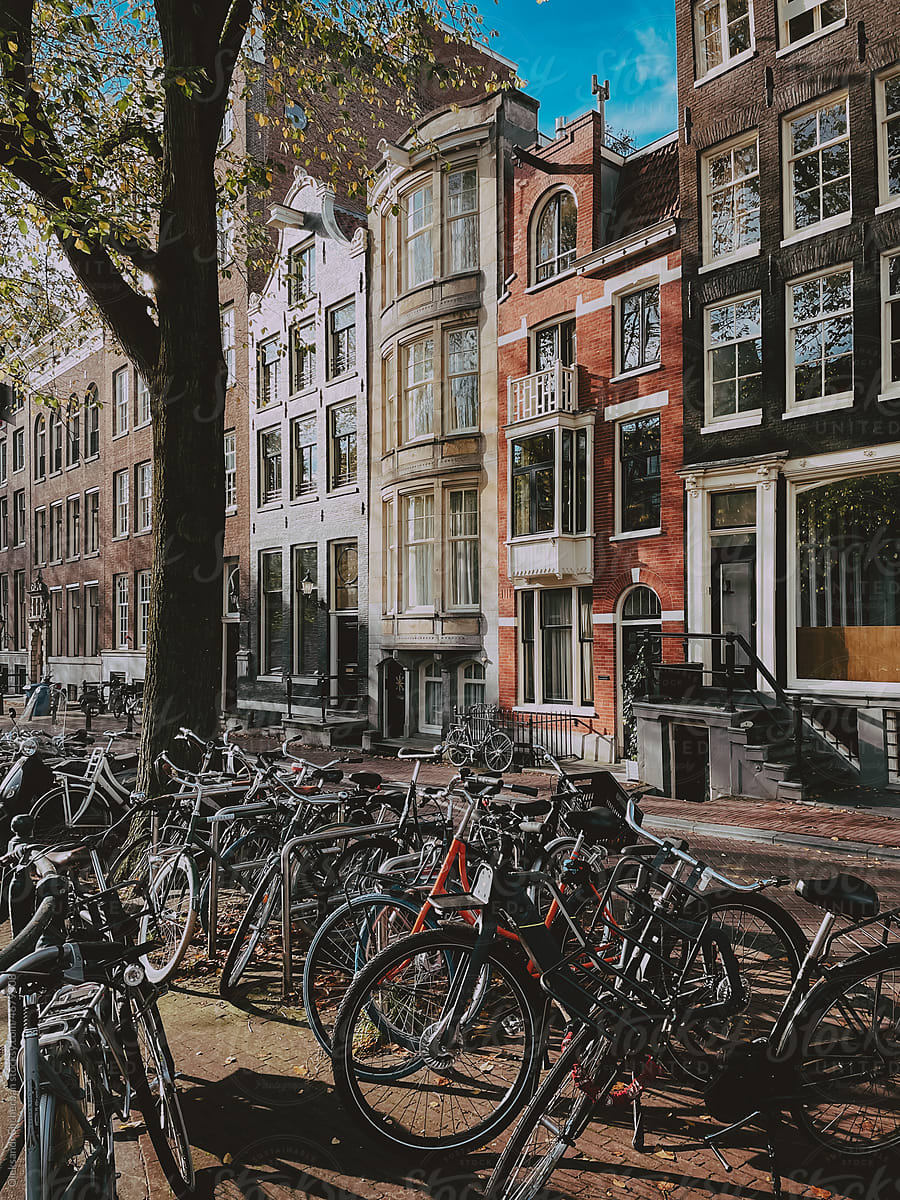 Streen in Amsterdam with bike parking and typical dutch houses