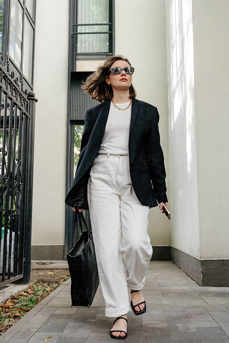 Confident woman in chic monochrome outfit