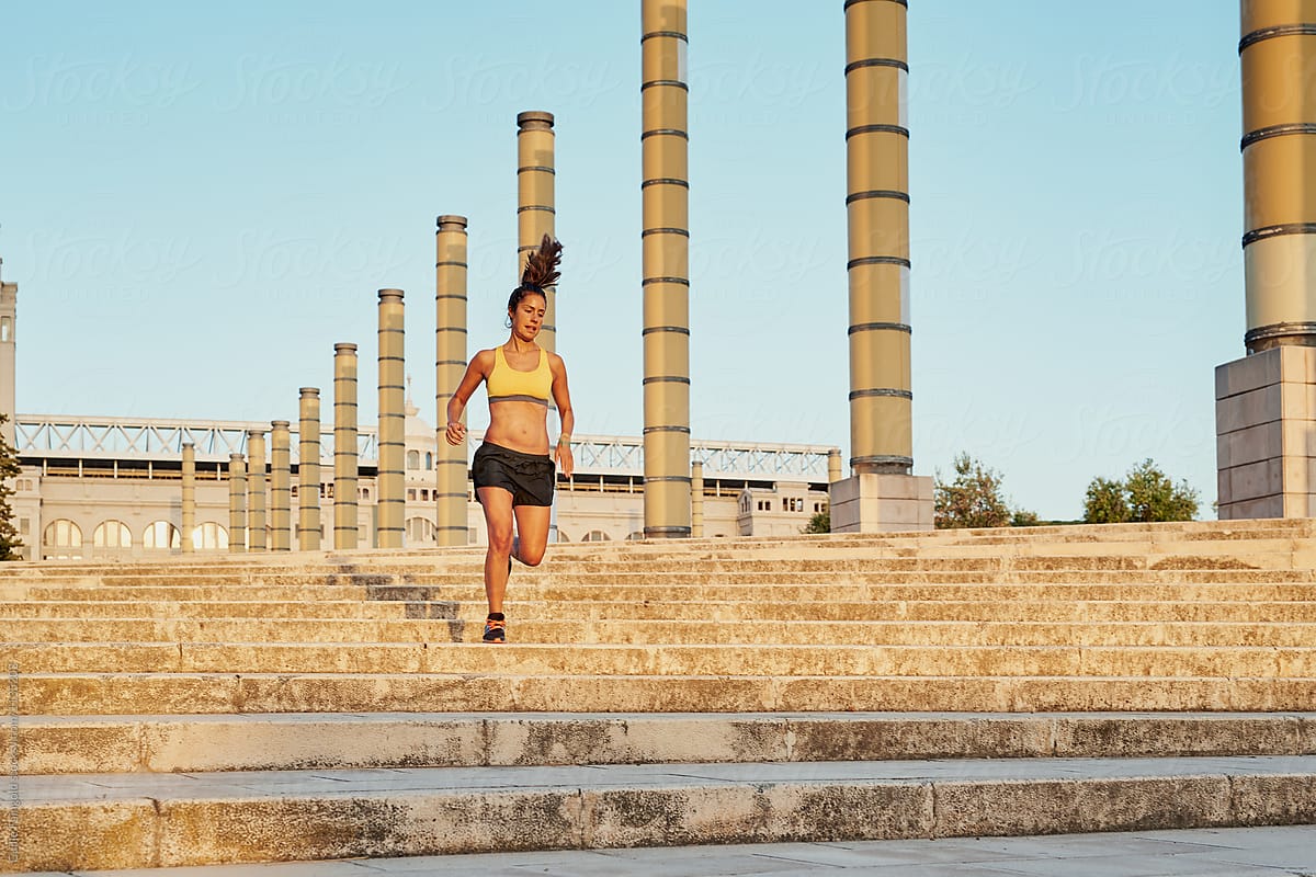 Athletic woman running on steps