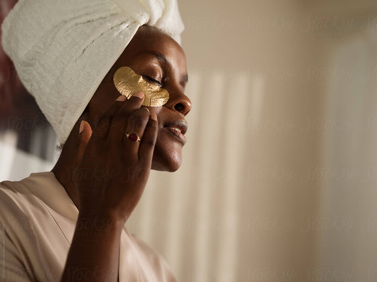 Dreamy woman touching eye mask