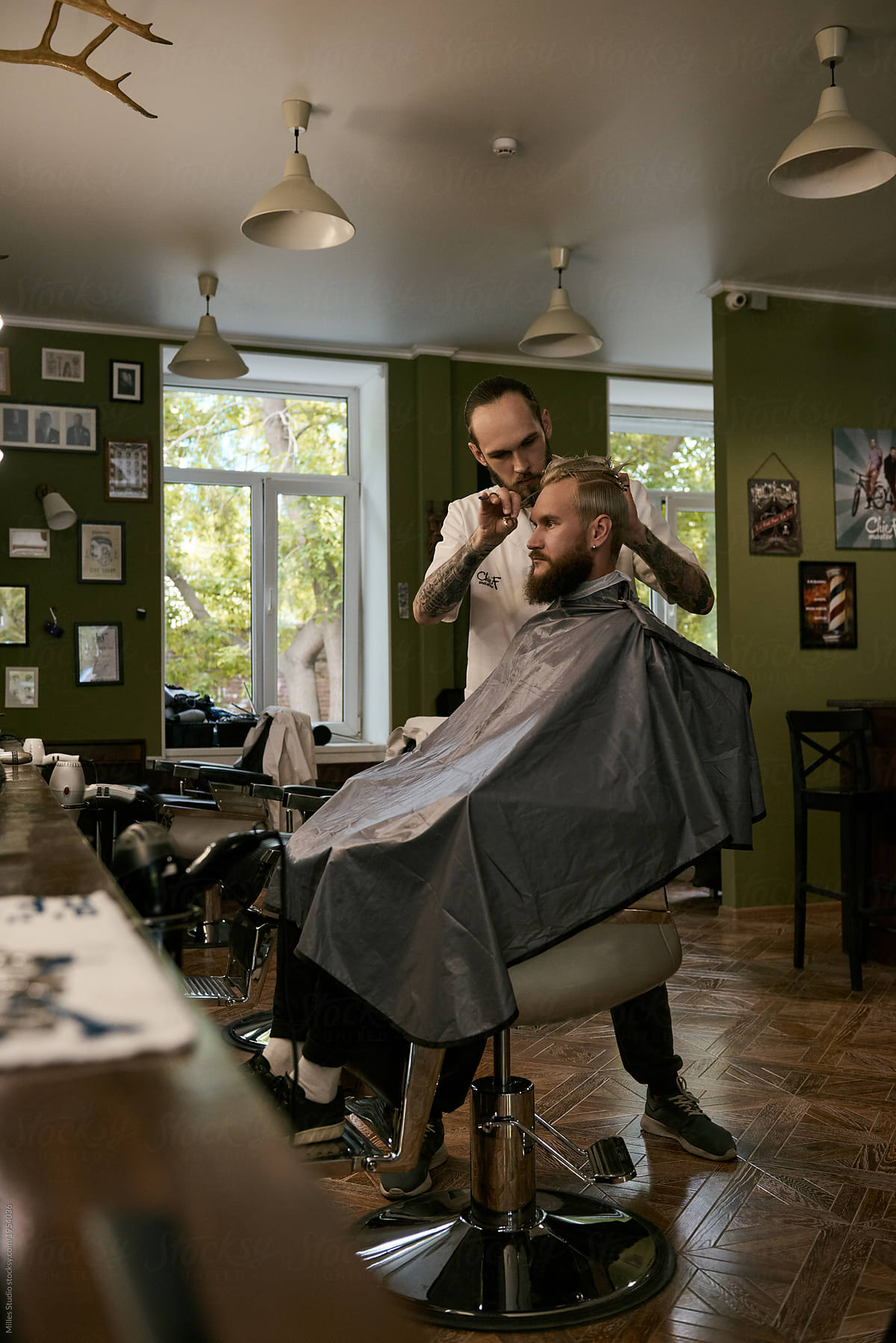 Man cutting hair of bearded client