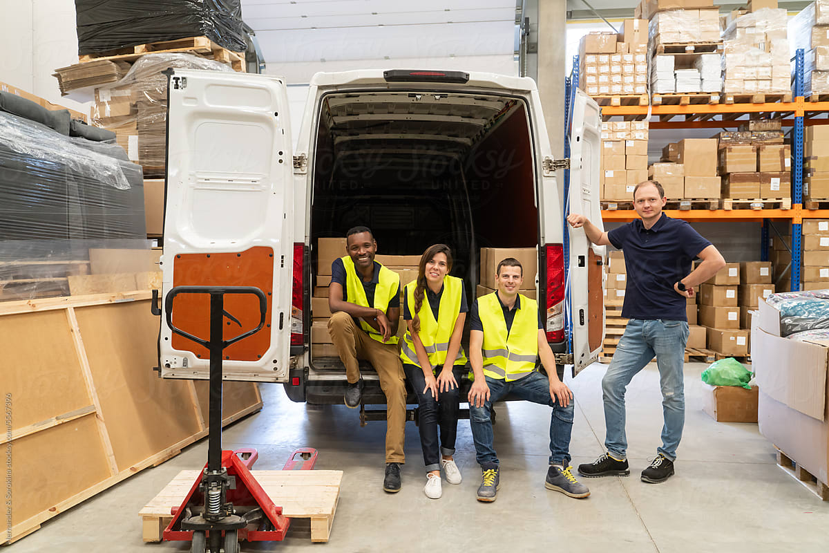 Warehouse Workers And Driver In Front Of The Van