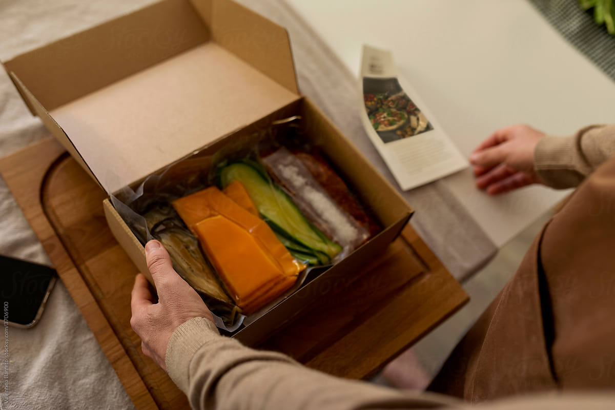men open a delivery box meal kit