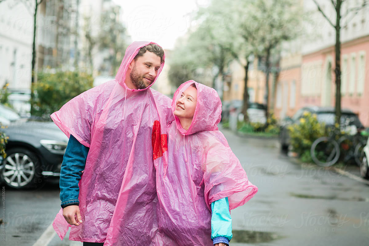 Walking talking couple in pink raincoat