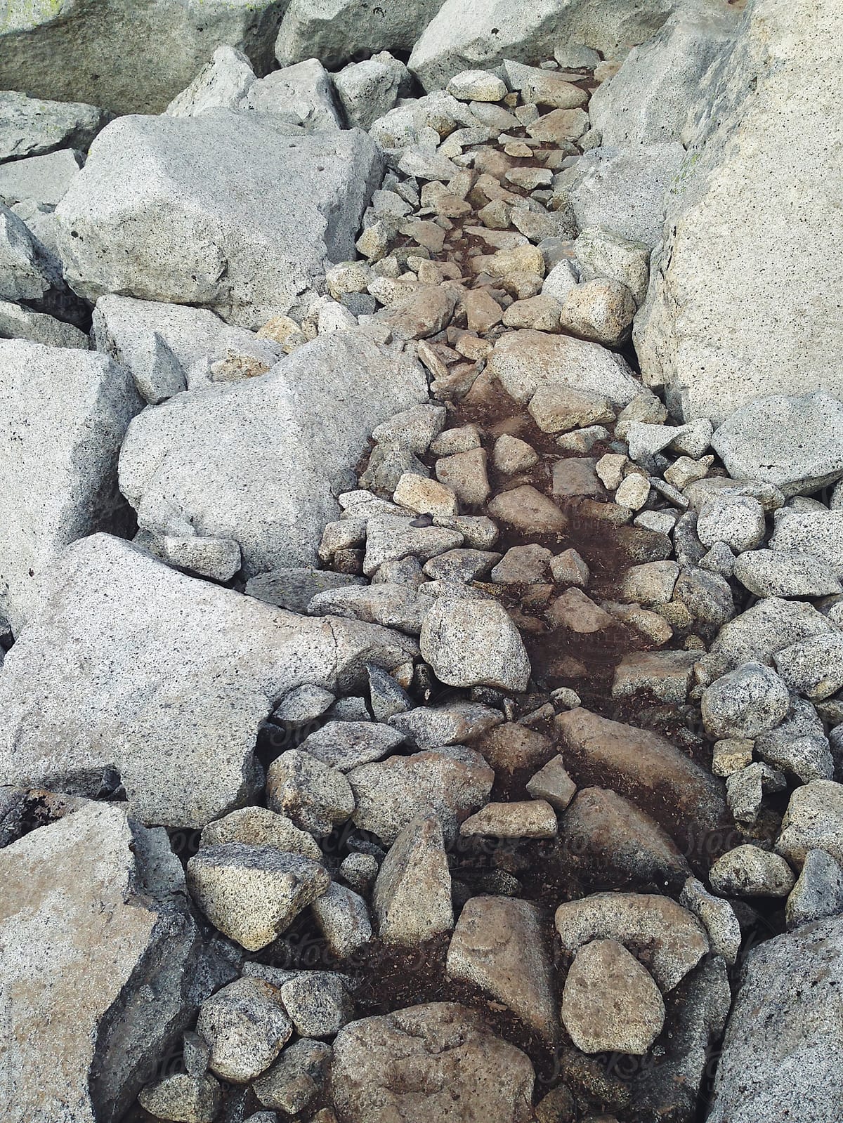 Hiking trail through boulders and stones
