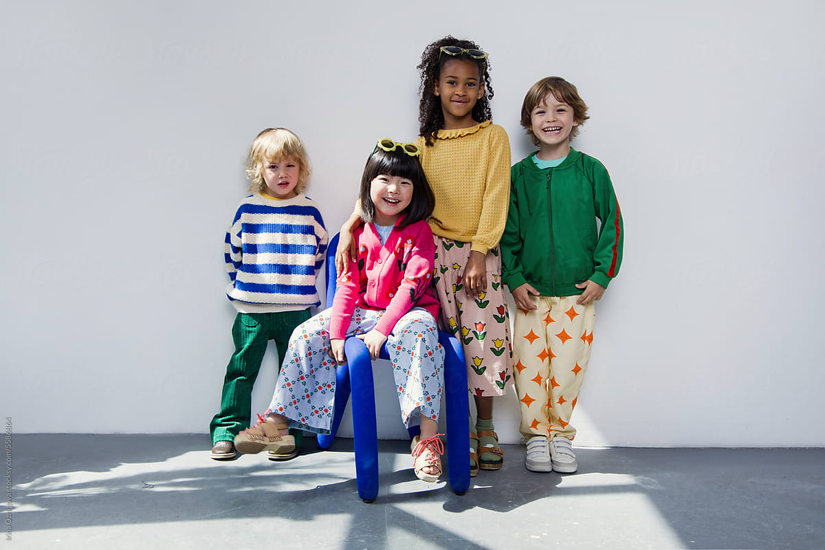 Four cute and little  kids  in studio.