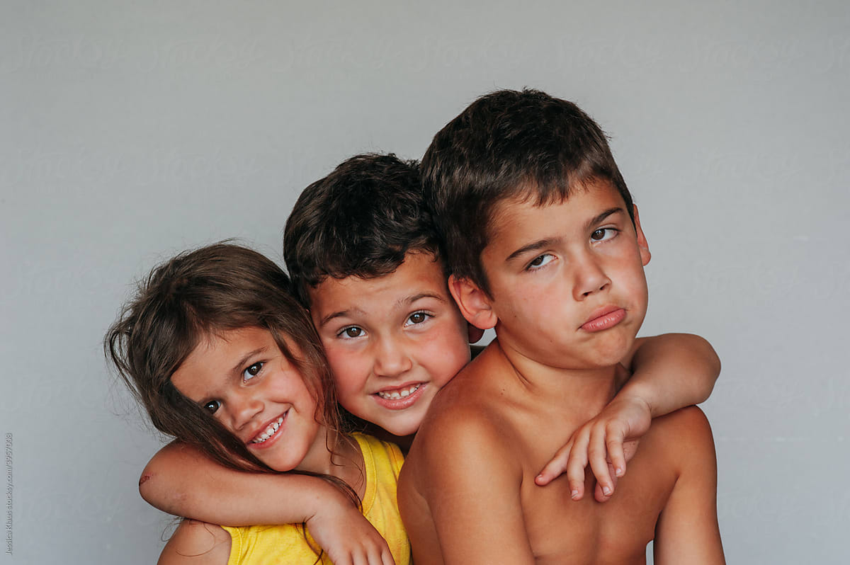 Funny portrait of three siblings.