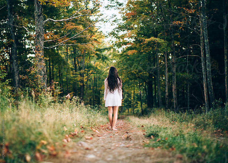 A Beautiful Young Woman Walks Alone In A Dark Woods By Howl Stocksy