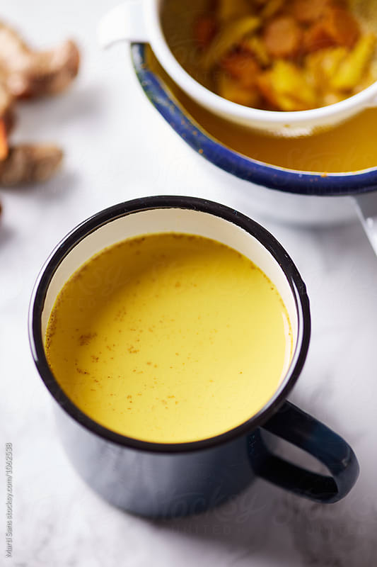 Close-up of yellow turmeric tea in mug