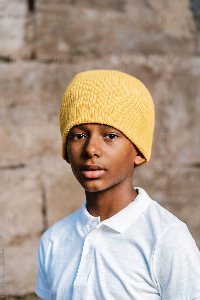 Black preteen in beanie looking at camera