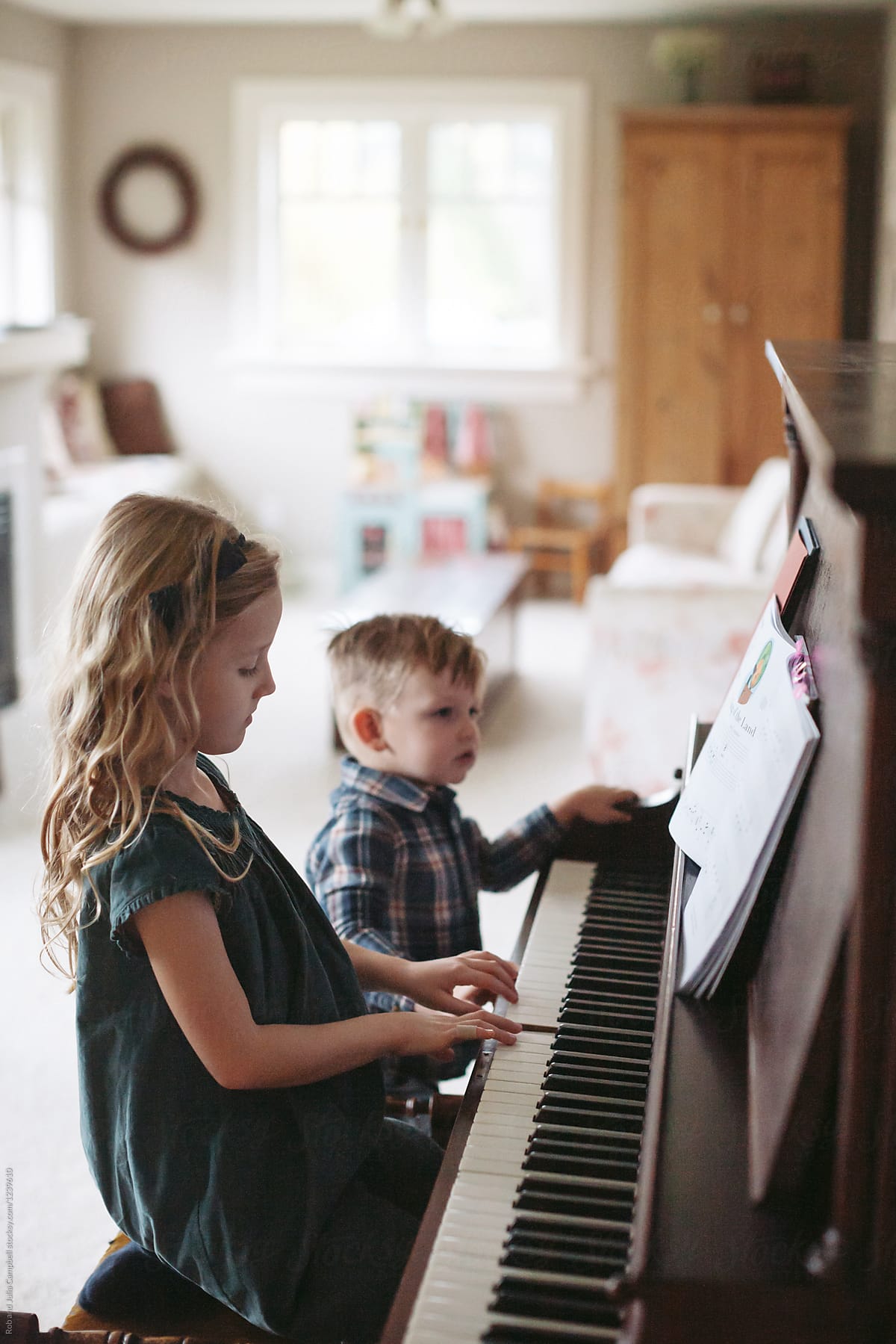 Little Girl Playing Piano By Stocksy Contributor Rob And Julia little-girl-playing-piano-by-stocksy-contributor-rob-and-julia