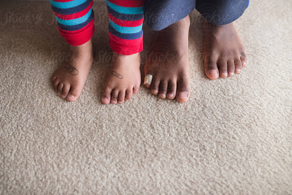 Siblings bare feet with bandages drawn on