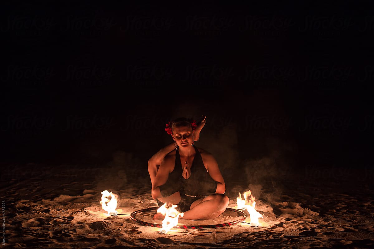 Woman Sitting in a Fire Circle
