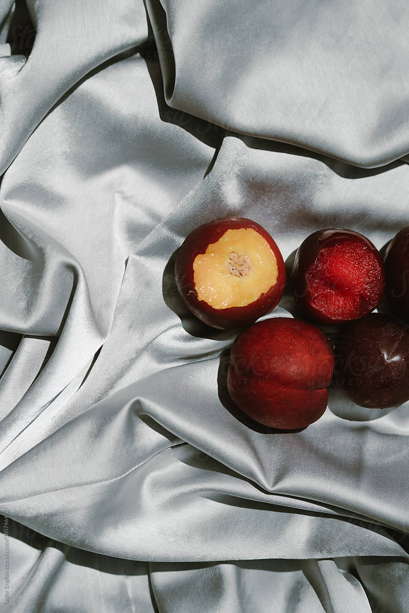 Plums and nectarines are bundled in silver silk