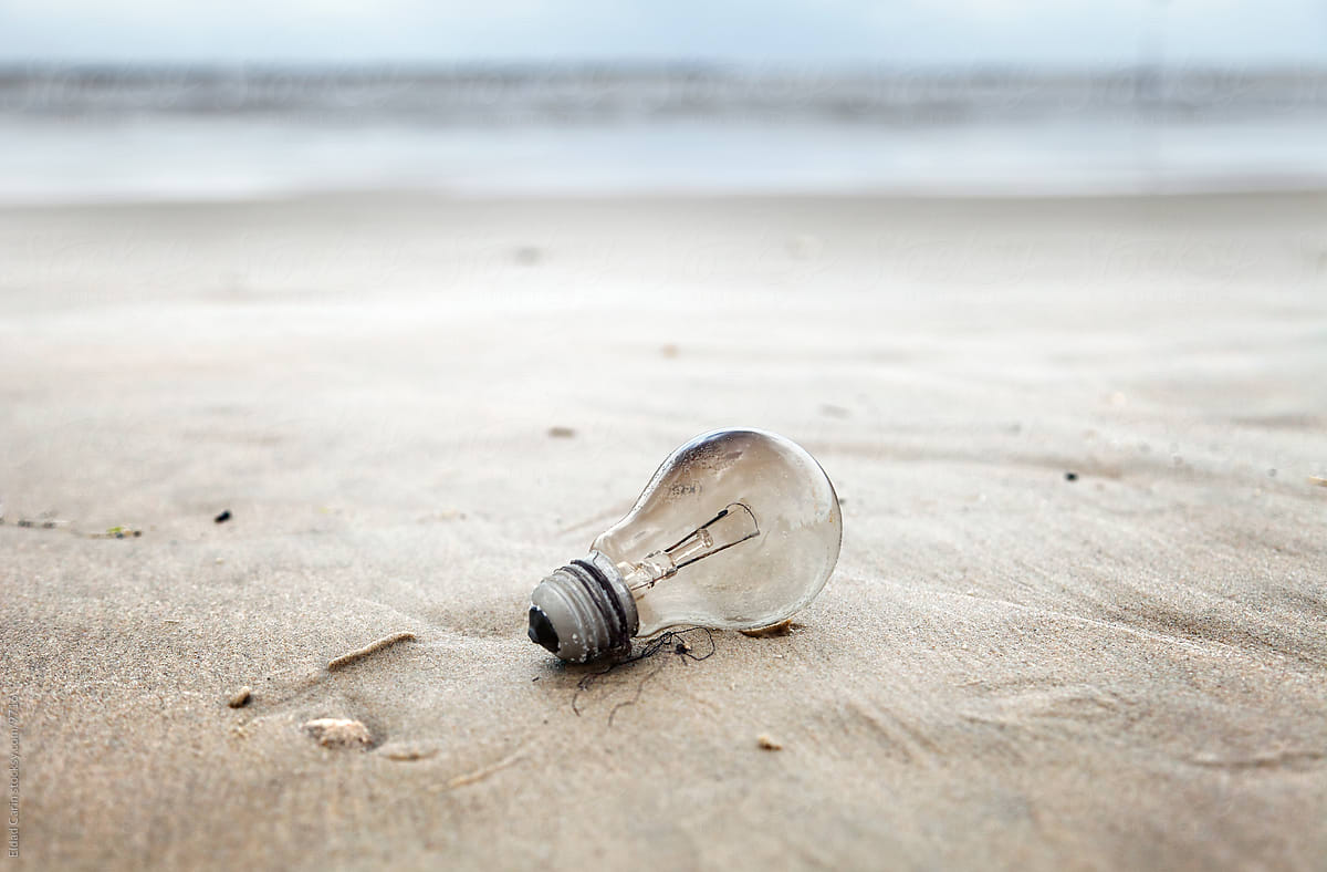 Burnt Light Bulb on a Beach - Environment