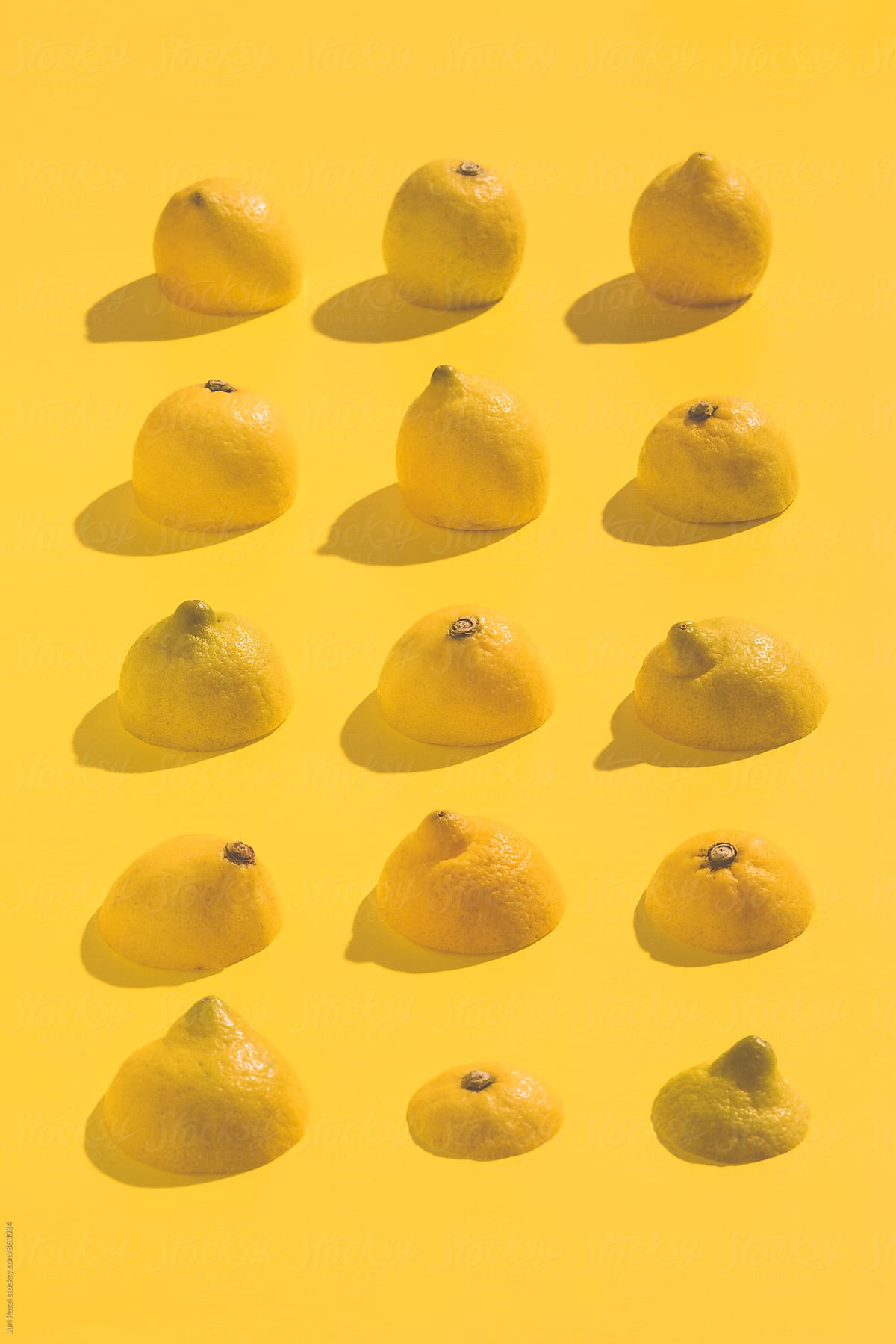 Yellow lemons on a yellow background