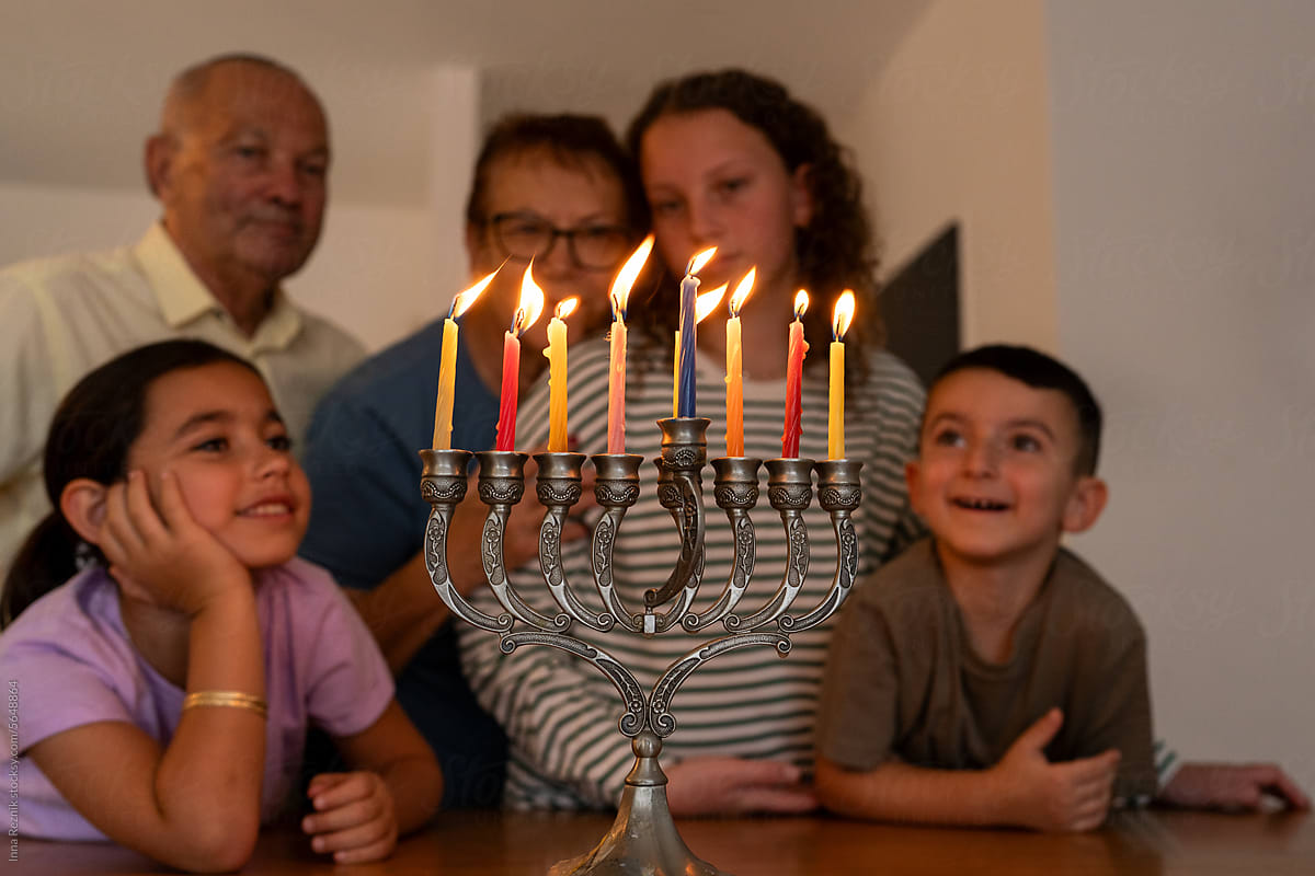 Jewish Family Celebrates Hanukkah with Glowing Candles.