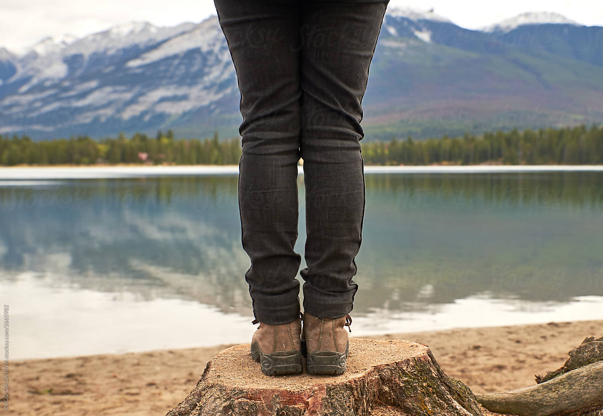 Woman\'s feet in front of the lake