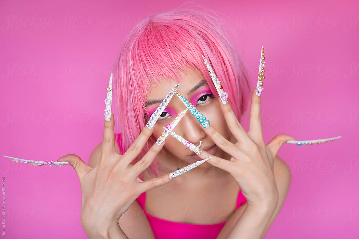 Asian woman with pink hair and trendy nails