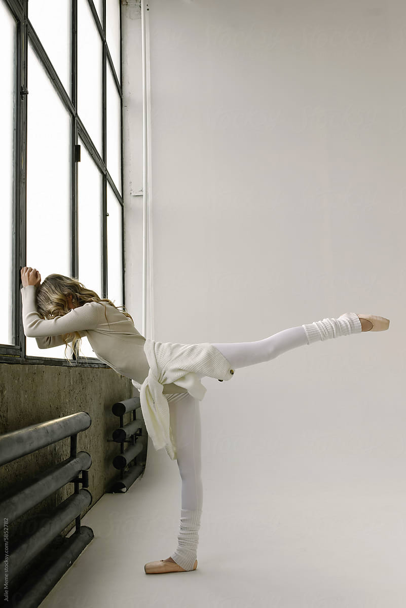 Ballet Dancer Practicing by Large Windows During Morning