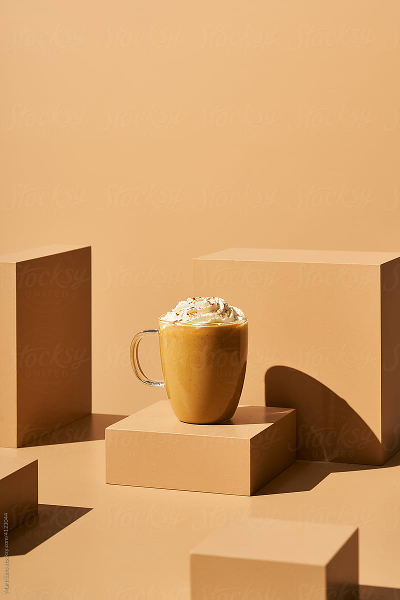 Mug of coffee with whipped cream and cinnamon