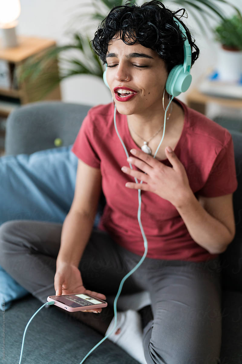Woman listening to music and singing