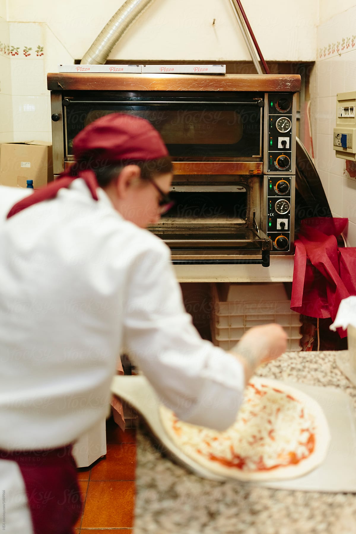 Female Pizza Chef Working in a Restaurant Kitchen. Small Busines