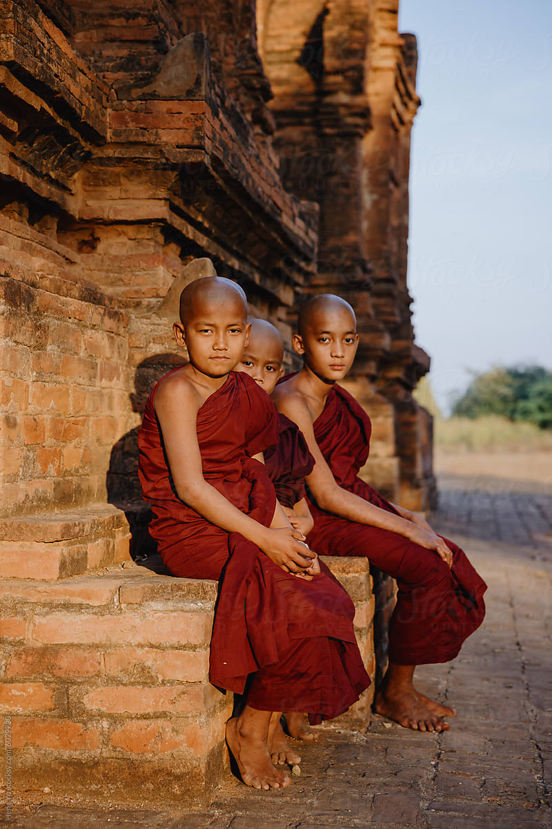 Young Novice monks sitting on temple steps