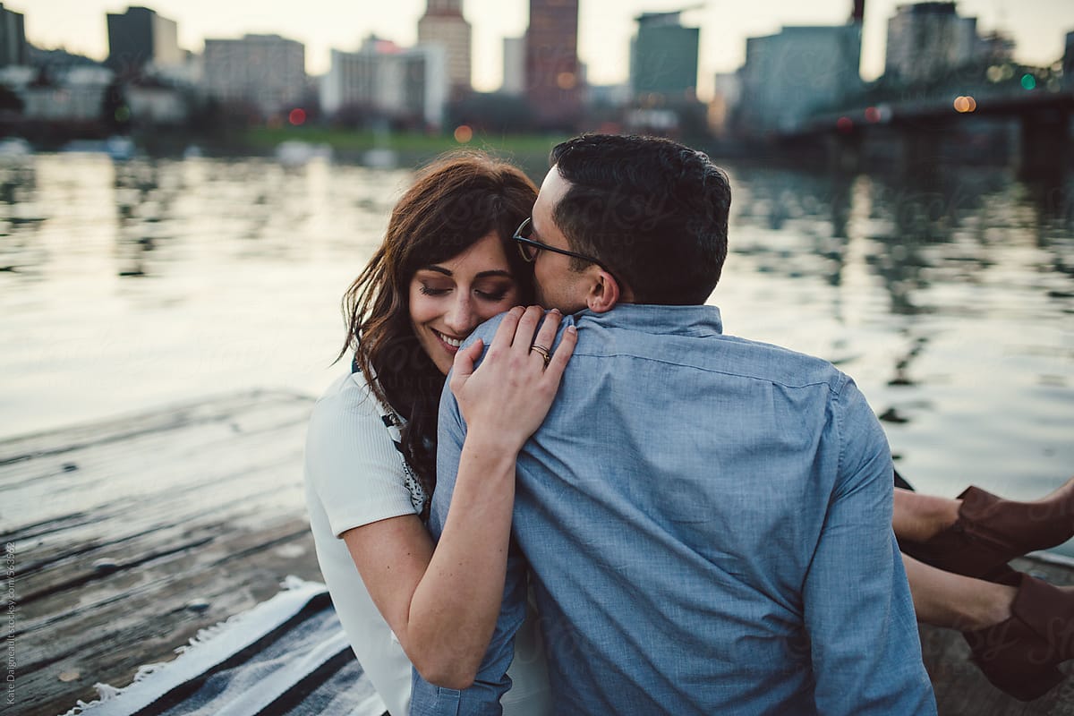 Attractive Couple Sitting On A River Pier At Dusk By Stocksy Contributor Kate Ames Stocksy
