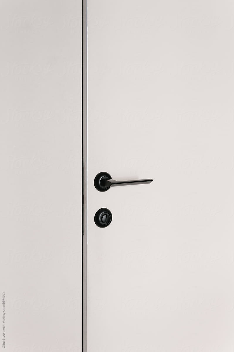 White door with black handle on cupboard